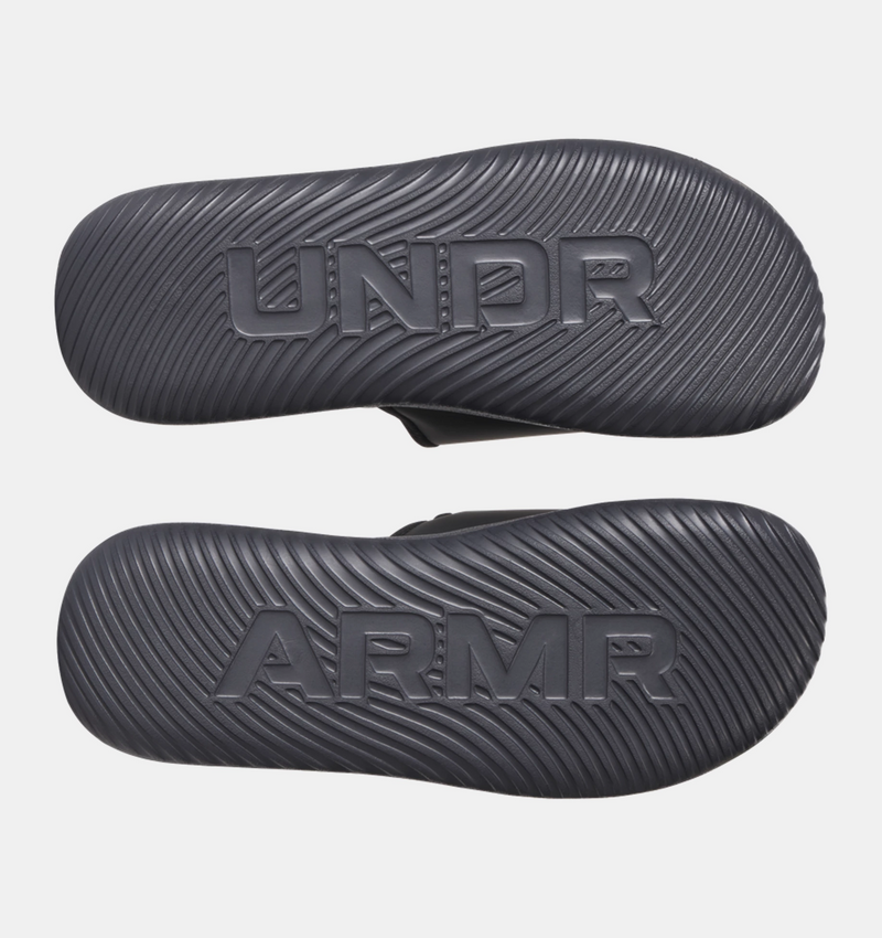 Under Armour Ignite Pro 8 Slides outsole in black with textured grip pattern and embossed branding, sole/bottom view.