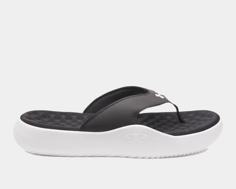 Under Armour Ignite Pro 8 T sandals with black synthetic straps, cushioned black textured footbed, and white foam outsole, side view.