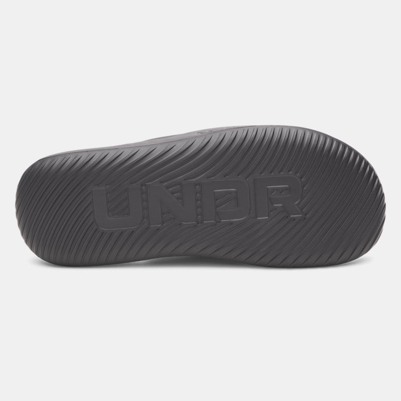 Under Armour Ignite Pro 8 T sandal outsole in black showing textured grip pattern and engraved branding, bottom view.