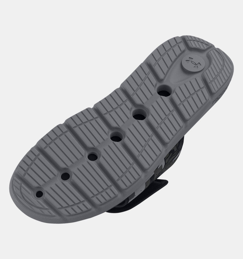 Under Armour Ignite Pro Freedom Slides sole view showing textured gray outsole with grooves and perforations for enhanced traction.