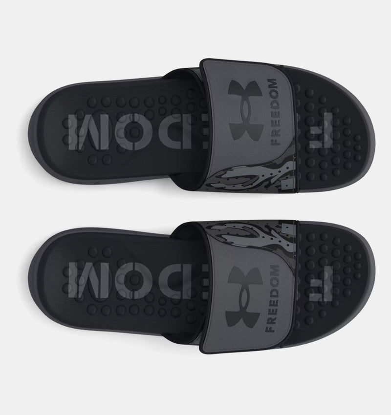 Under Armour Ignite Pro Freedom Slides in dark gray with textured footbed and branded strap, top view.