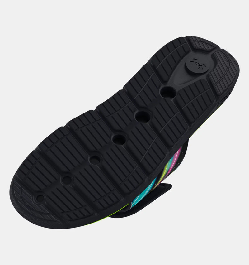 Under Armour Ignite Pro Graphic Strap Slides outsole with black rubber tread pattern and flex grooves, sole/bottom view.