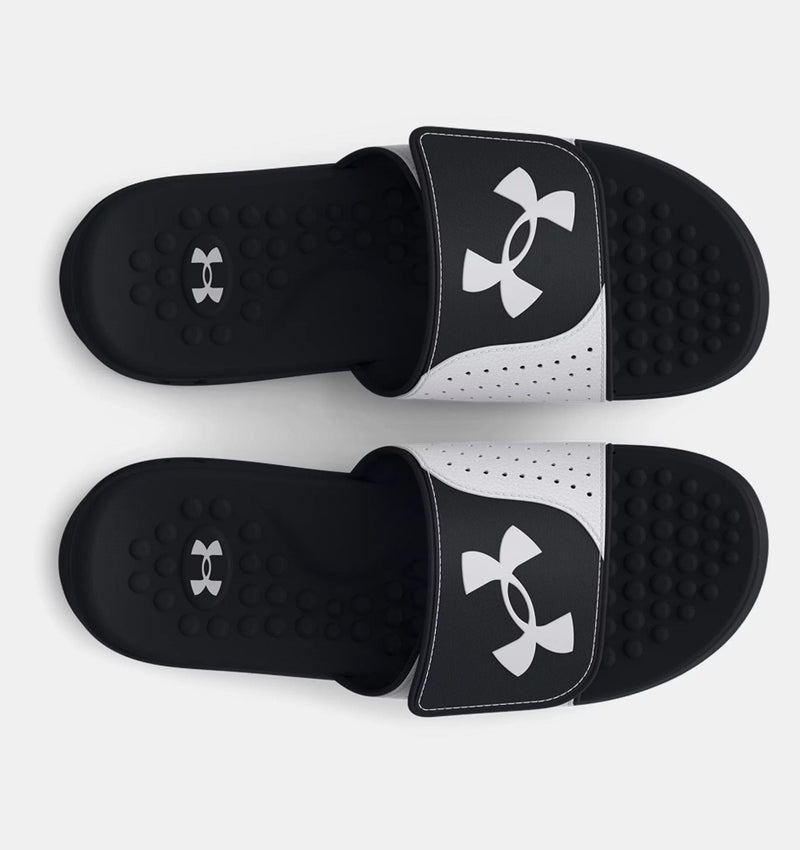 Under Armour Ignite Pro SL sandals in black and white with perforated strap and textured footbed, top view.