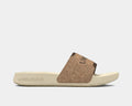 Under Armour Ignite Select Cork Slides with cork-textured strap and beige cushioned sole, side view.