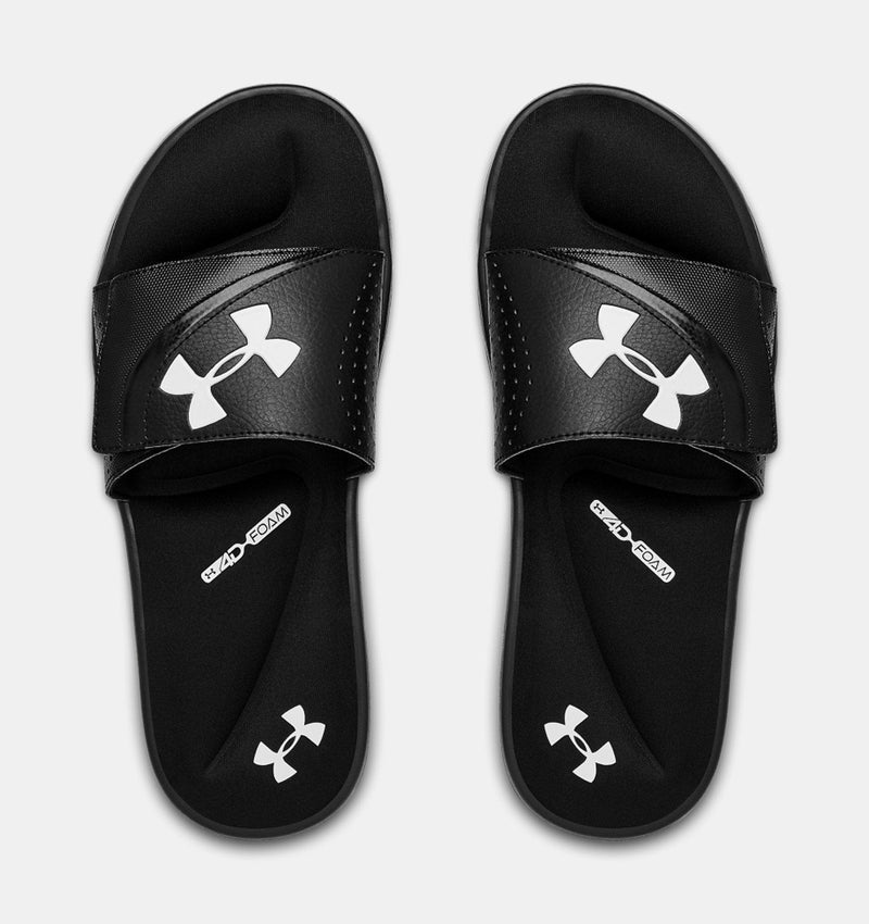 Under Armour Ignite VI SL sandals in black with white logo on strap and footbed, featuring cushioned foam sole, top view.