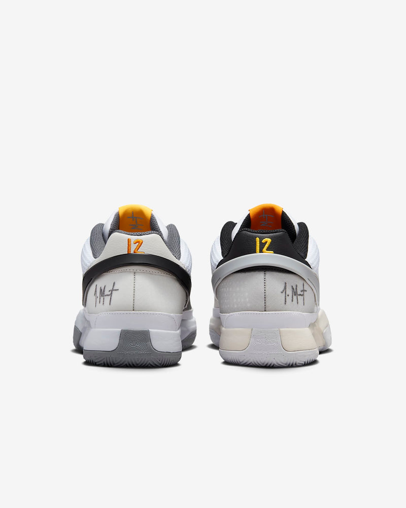 Nike Ja 1 "Wet Cement" basketball shoes in gray, black, and white with orange accents, back view showing heel details and "12" branding.