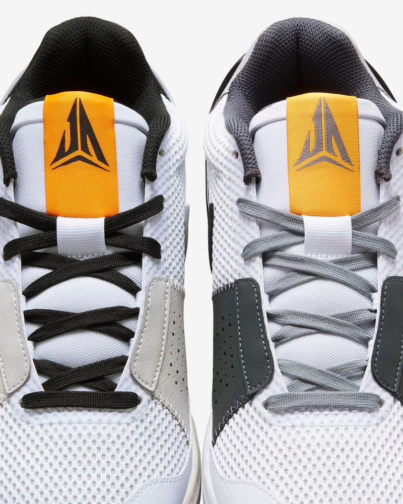 Nike Ja 1 "Wet Cement" basketball shoes showing mesh upper, black and gray laces, and orange tongue logo, top view.