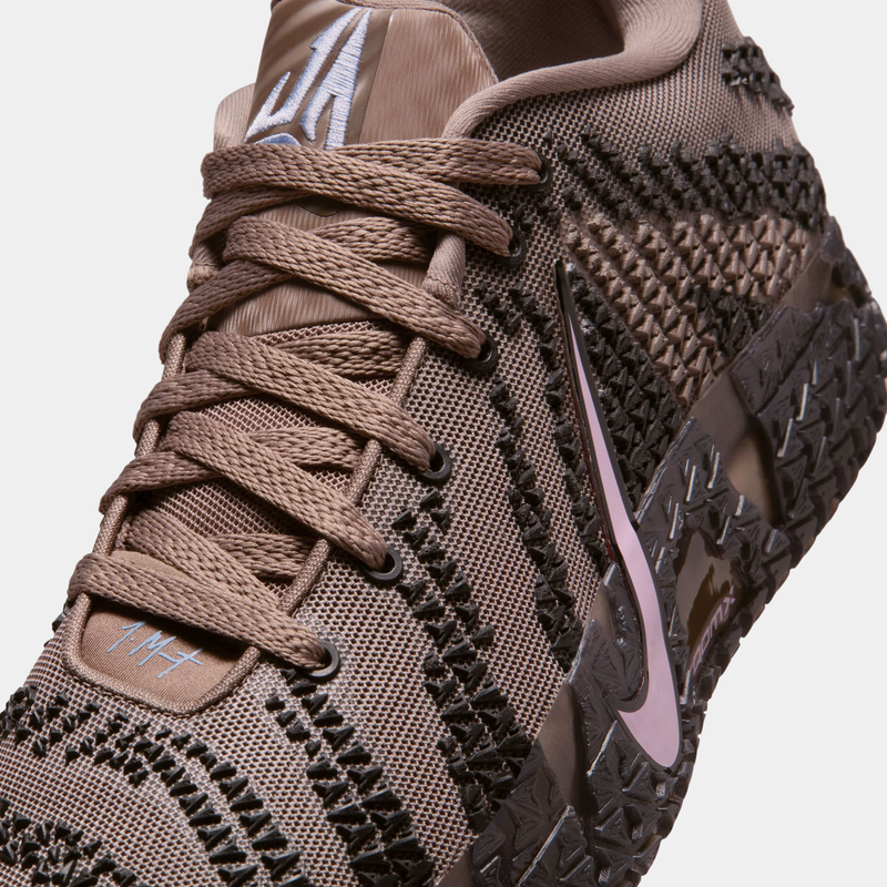 Nike Ja 3 "Mink Brown" basketball shoes featuring a textured brown mesh upper, black detailing, and a sleek pink Swoosh logo, close-up view.