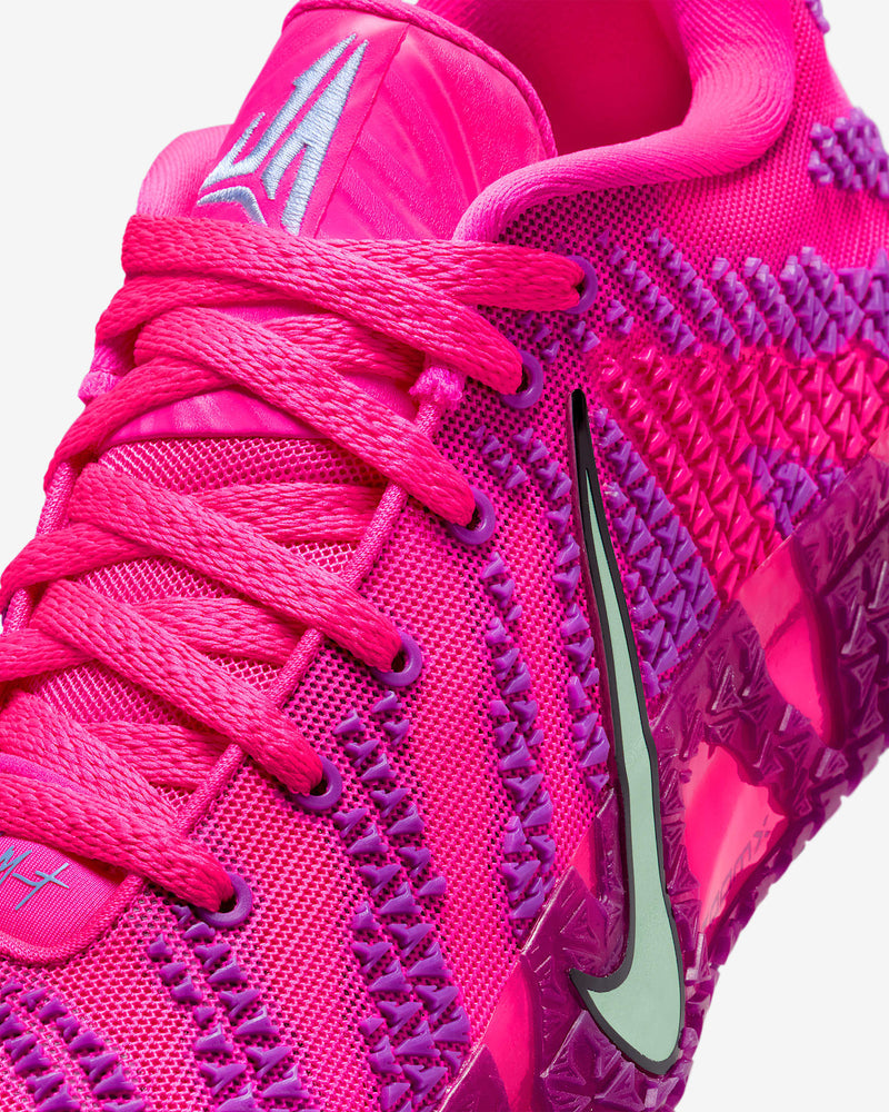 Nike Ja 3 "Price of Admission" basketball shoes with vibrant pink mesh upper, purple accents, and silver Swoosh logo, close-up angle.