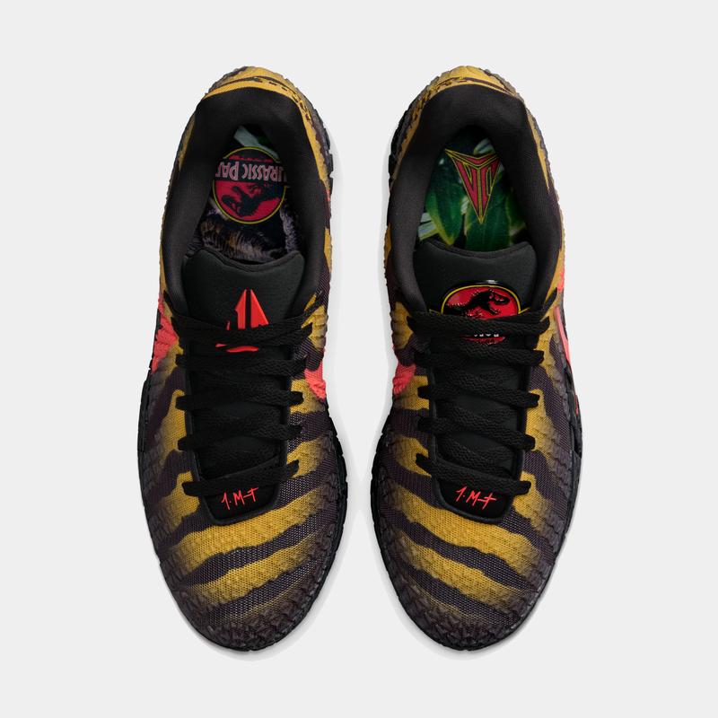 Nike Ja 3 x Jurassic Park "Raptor" basketball shoes with yellow and black reptile-inspired pattern, red accents, and Jurassic Park-themed graphics, top view.