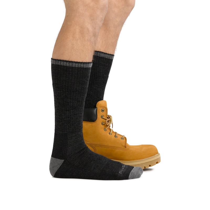 Darn Tough John Henry Boot Midweight Work Sock in dark gray with reinforced heel and toe, worn with work boots.