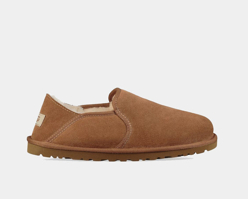 UGG Kenton slippers in chestnut brown suede with plush shearling lining and durable rubber outsole, side view.