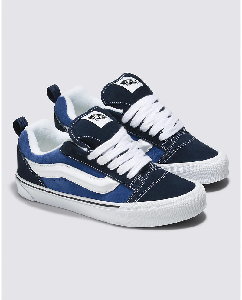 Vans Knu Skool Core sneakers in navy blue and white with suede upper, padded collar, and white laces, angled front view.