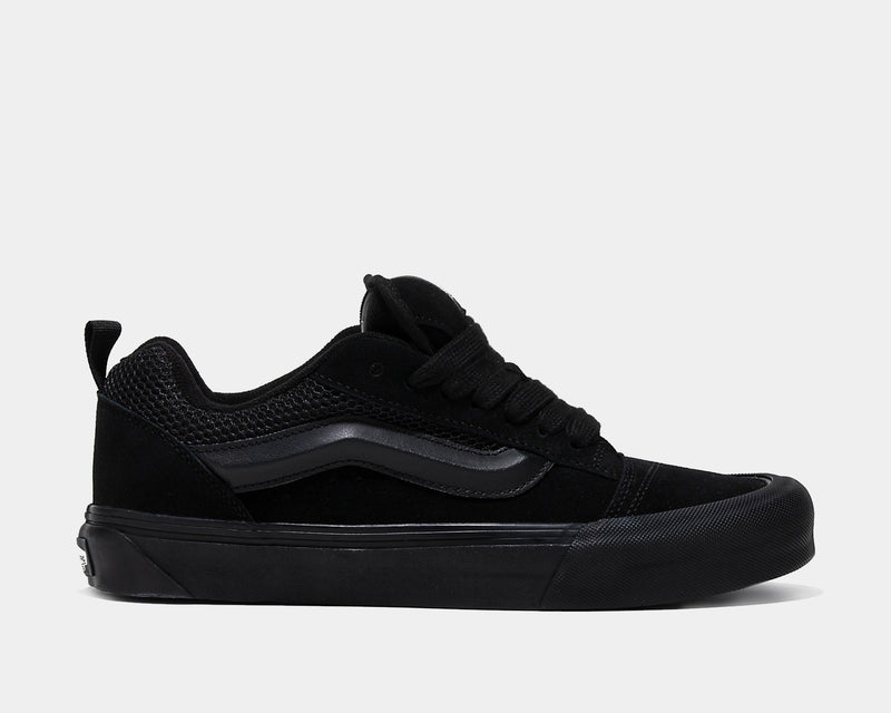 Vans Knu Skool Core sneakers in all-black with suede and mesh upper, signature side stripe, and chunky sole, side view.