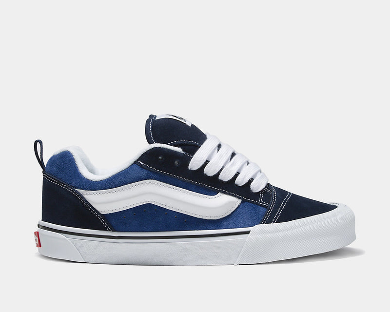 Vans Knu Skool Core sneakers in navy blue suede with white leather accents, padded tongue, and thick white laces, side view.