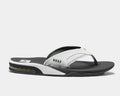Reef Leather Fanning Flip Flops in black and white with perforated leather strap, cushioned footbed, and built-in bottle opener, side view.