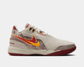 Nike LeBron NXXT Gen AMPD basketball shoes side view in beige with red and yellow accents, intricate patterned overlays, and textured red outsole.