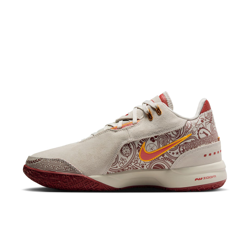 Nike LeBron NXXT Gen AMPD basketball shoes, side view in cream with red paisley-inspired design, orange accents, and Zoom Air cushioning.