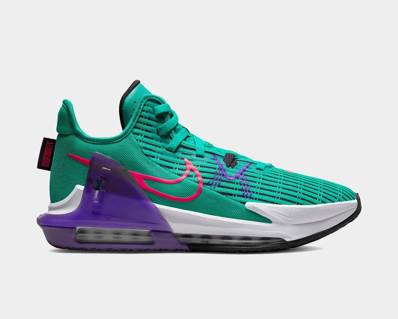 Nike LeBron Witness 7 basketball shoes in green with pink Swoosh logo, purple heel clip, and cushioned midsole, side view.