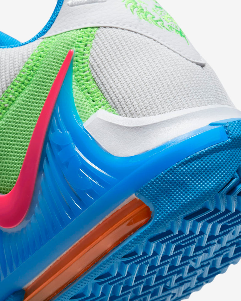 Nike LeBron Witness 7 basketball shoe heel detail featuring vibrant green mesh, pink Swoosh, blue TPU accents, and orange cushioning.