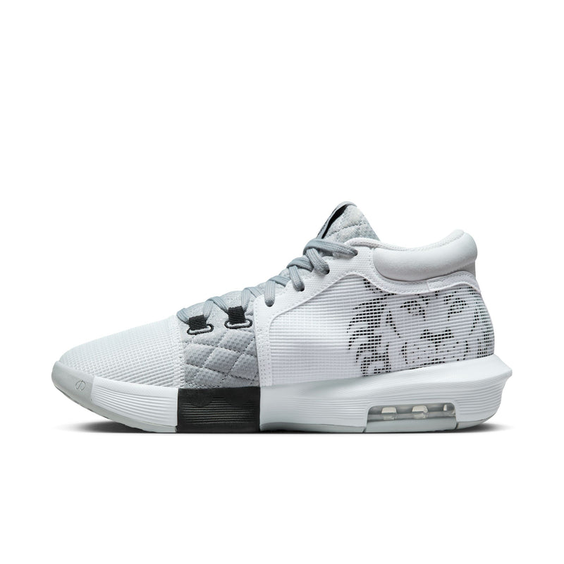 Nike LeBron Witness 8 basketball shoes in white and gray with quilted mesh upper, lion graphic on side, and visible Air cushioning, side view.