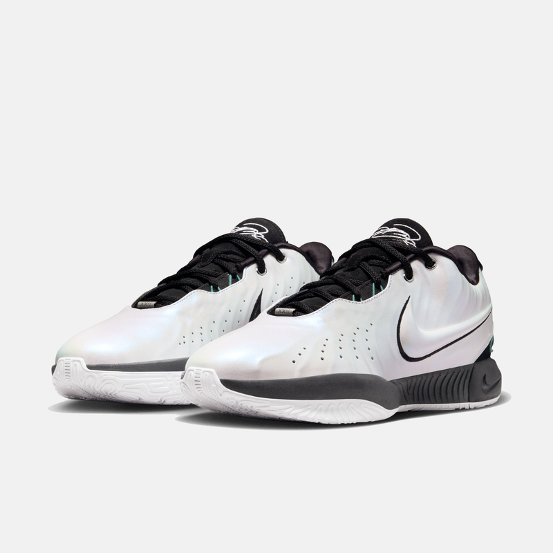 Nike Lebron XXI "Conchiolin" basketball shoes with iridescent white upper, black accents, and white outsole, front angle view.