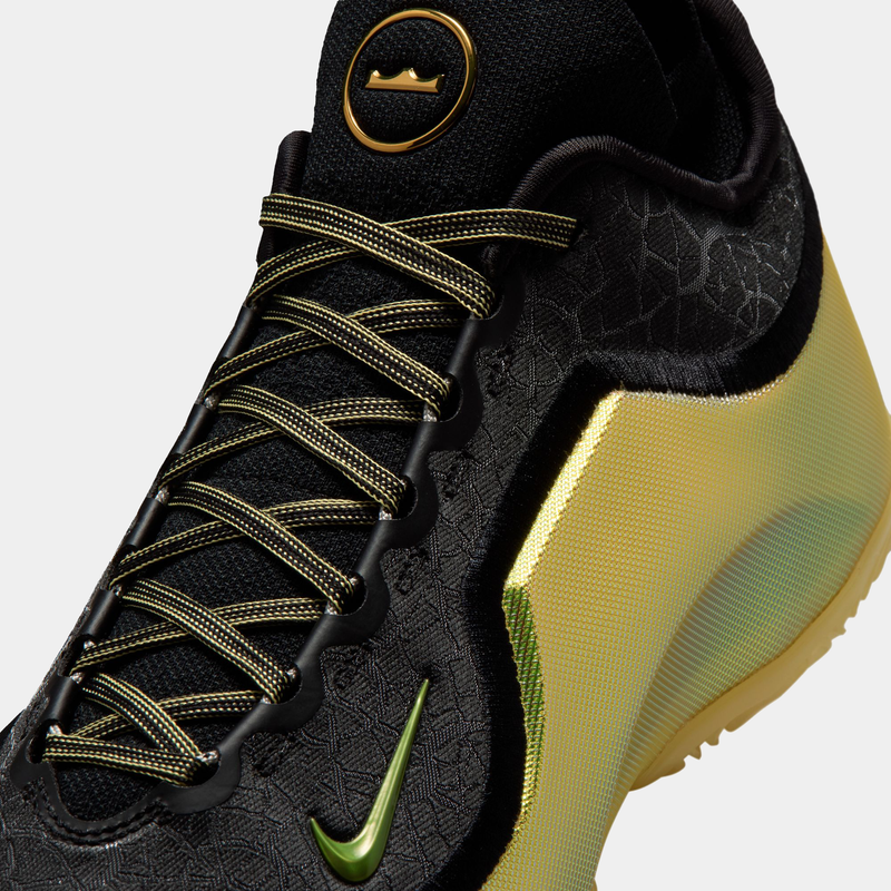 Nike LeBron XXIII Elite "Hurt Feelings" basketball shoes, black woven upper with golden accents, green Nike Swoosh, close-up view