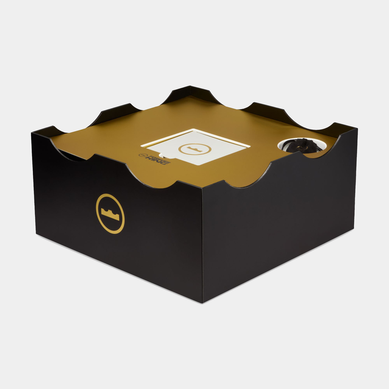 Nike LeBron XXIII "Grand Opening" packaging box in black and gold with crown logo and layered design, angled side view.