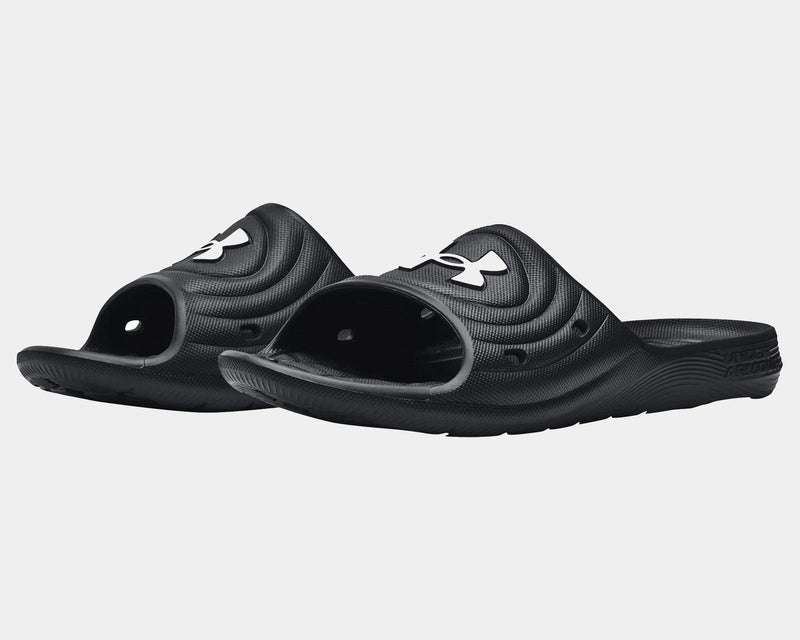 Under Armour Locker IV SL black slides with textured EVA material, drainage holes, and contoured footbed, angled front view