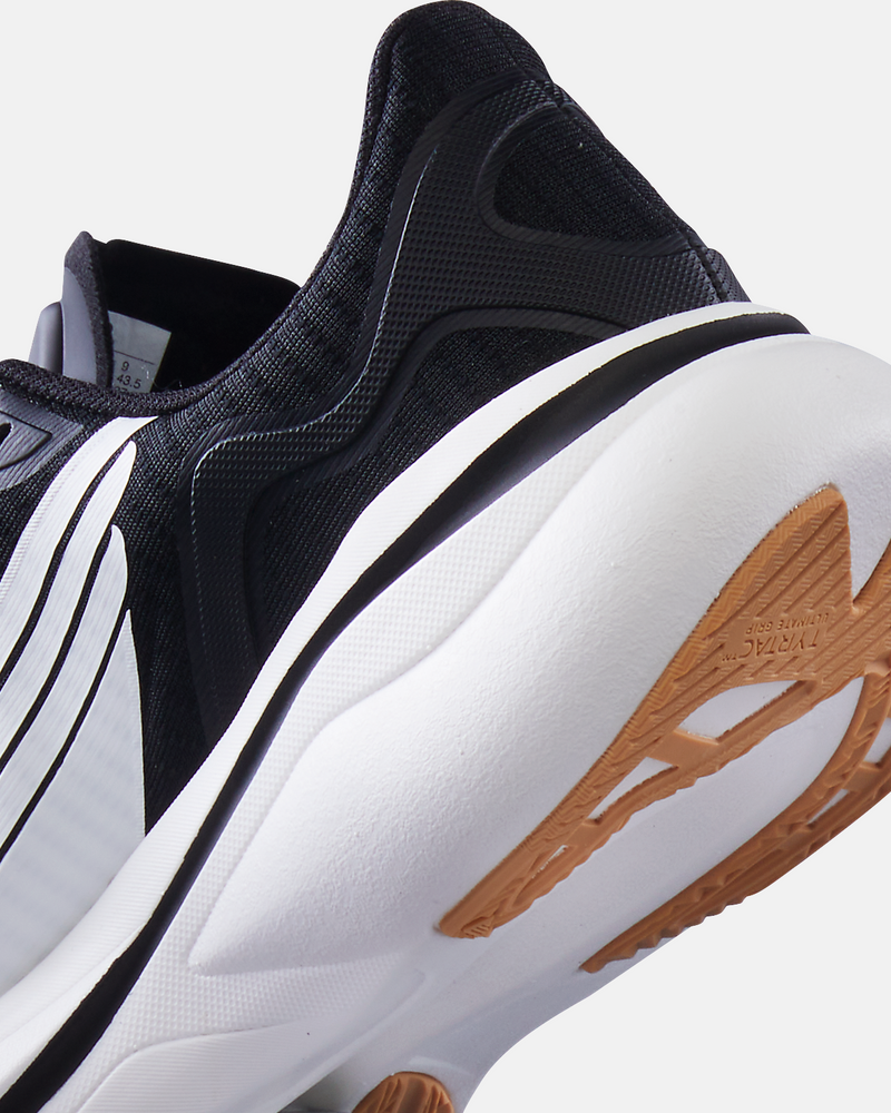 TYR Maverick V1 Runner shoes in black with white accents, cushioned midsole, and durable outsole with tan rubber grip, close-up heel and sole view.