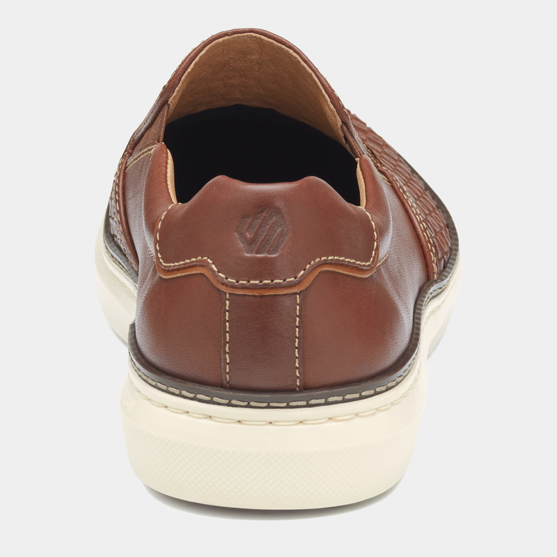Johnston & Murphy McGuffey 2 Woven Slip-on shoes back view, showing brown leather upper, embossed logo, and stitched detailing.
