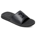 The DC Shoes Men's Bolsa Slides feature a wide strap with an embossed logo and a textured footbed for grip and comfort—perfect for everyday wear or relaxing after skating.