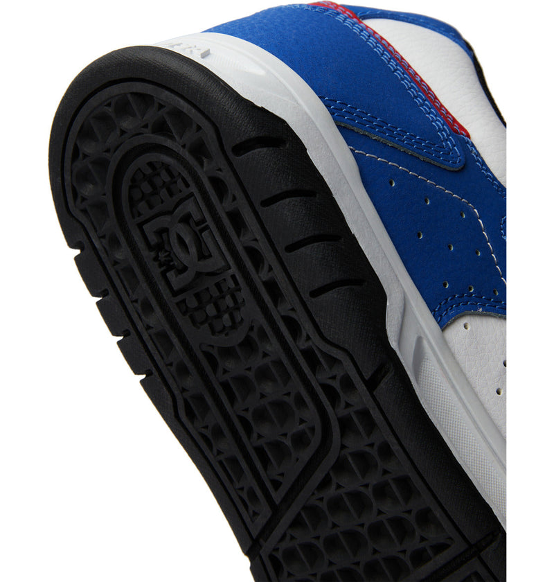 Close-up of DC Shoes Men's Stag sole, featuring black rubber tread with a textured pattern, the DC Shoes logo, blue and white leather upper accents, visible stitching, and the durable cupsole iconic to this model.