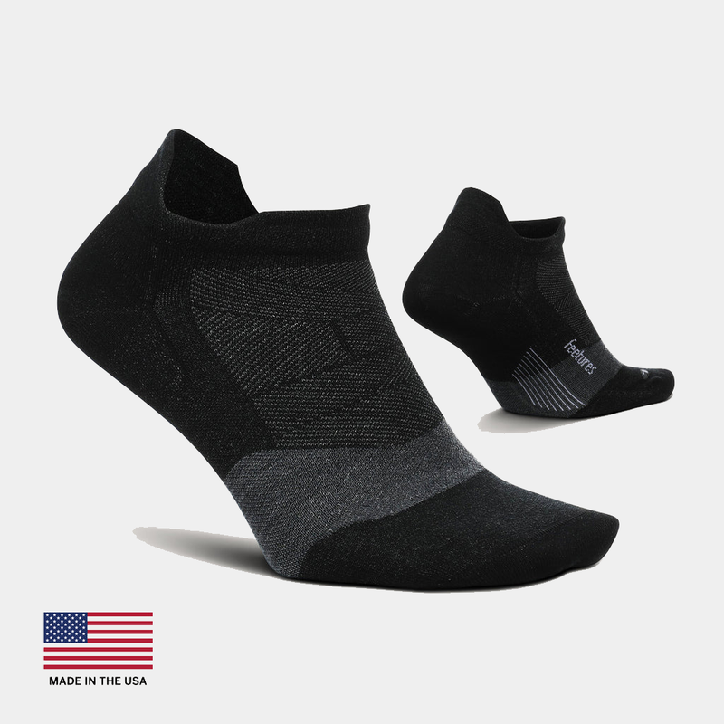 Feetures Merino 10 Ultra Light Cushion No Show Tab socks in black with gray accents, featuring moisture-wicking Merino wool blend, side angles.