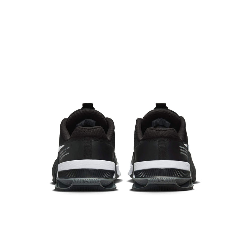 Nike Metcon 8 training shoes back view in black with white heel accents and durable outsole for stability.