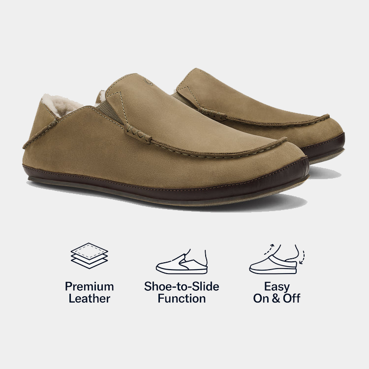 OluKai Moloa Slipper shoes in tan leather with soft lining, hand-sewn stitching, and foldable heel, side angled view.