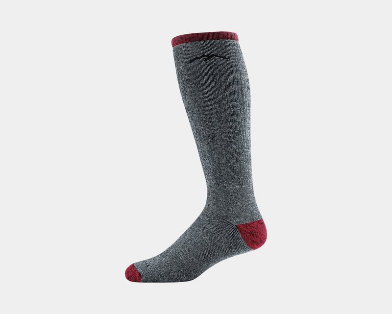 Darn Tough Mountaineering Over-The-Calf Extra Cushion socks in gray with red accents and reinforced toe and heel, side view.