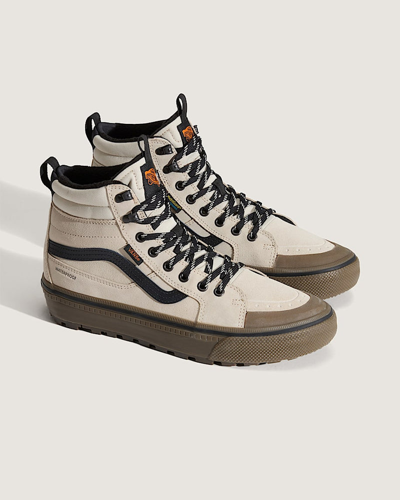 Vans MTE Sk8-Hi Waterproof Insulated Shoe, high-top sneakers in beige with black accents, waterproof suede upper, and rugged brown sole, angled side view.