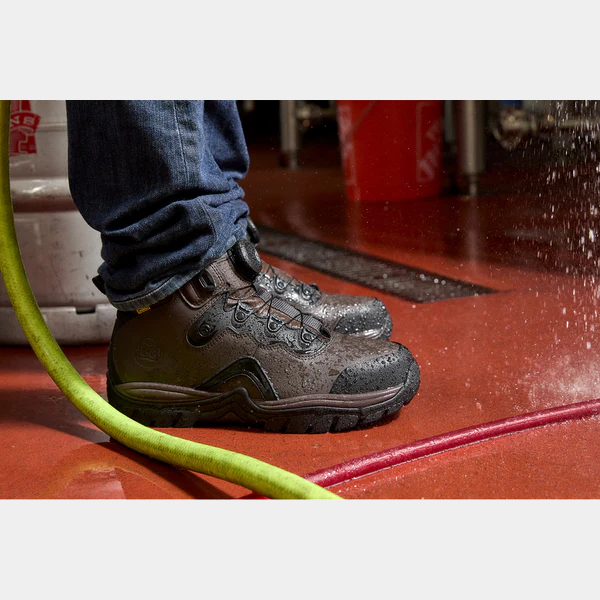 DC WorkCrew Navigator Work Hi Top Comp Toe with Met Guard work boots in dark brown leather, waterproof upper, and reinforced sole, shown in wet work environment.