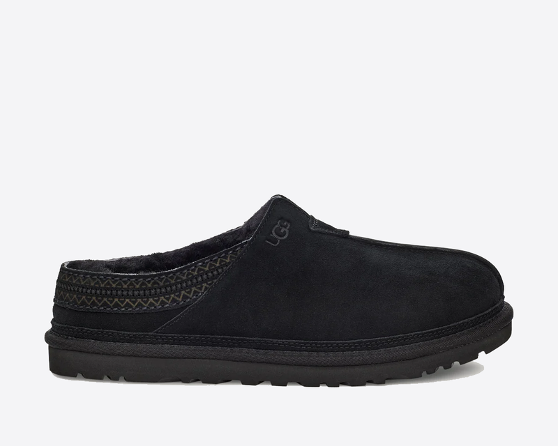 UGG Neuman slippers in black suede with woven trim accents and plush lining, side view showing durable outsole.