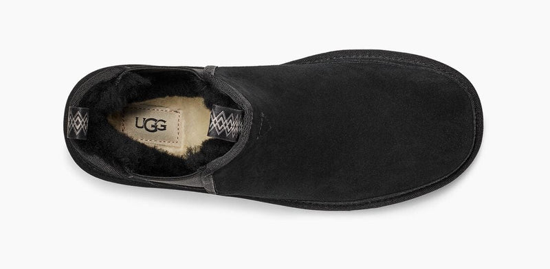 UGG Neumel Chelsea boots in black suede with cozy shearling lining, top view showing soft interior and branded insole tag.