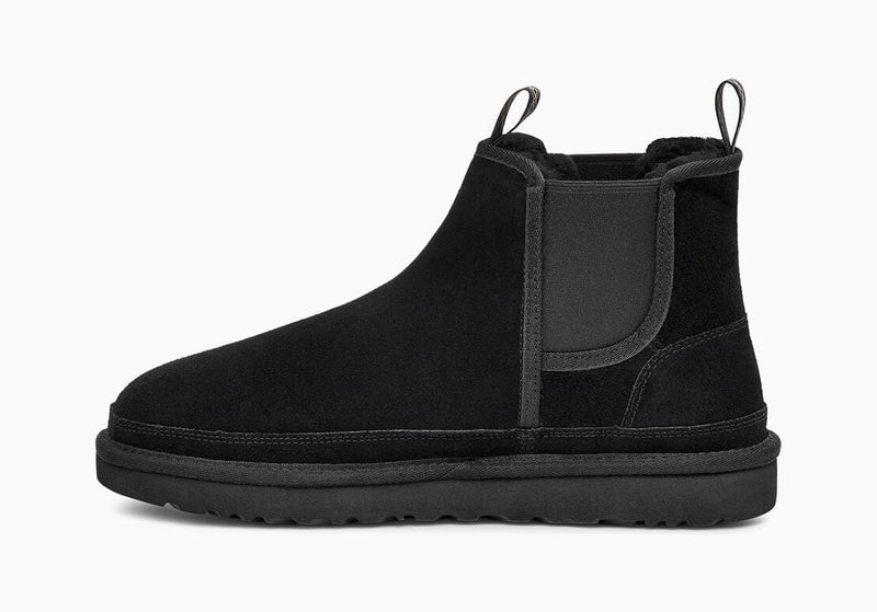 UGG Neumel Chelsea boots in black suede with elastic side panels and pull tabs, side view.