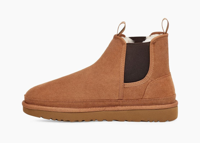 UGG Neumel Chelsea boots in chestnut brown suede with elastic side panels and pull tabs, side view.