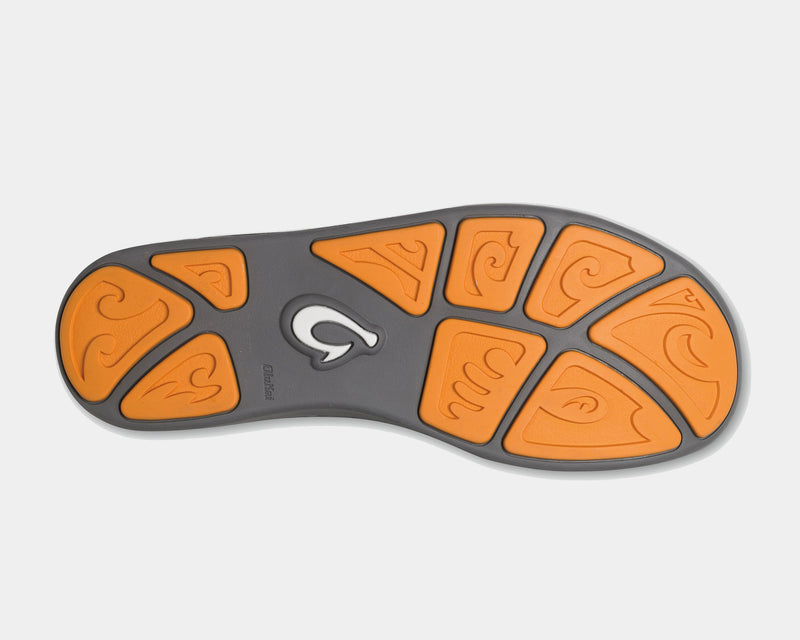 OluKai Nohea Mesh shoes outsole view with orange rubber inserts featuring wave-patterned designs and gray base for traction.