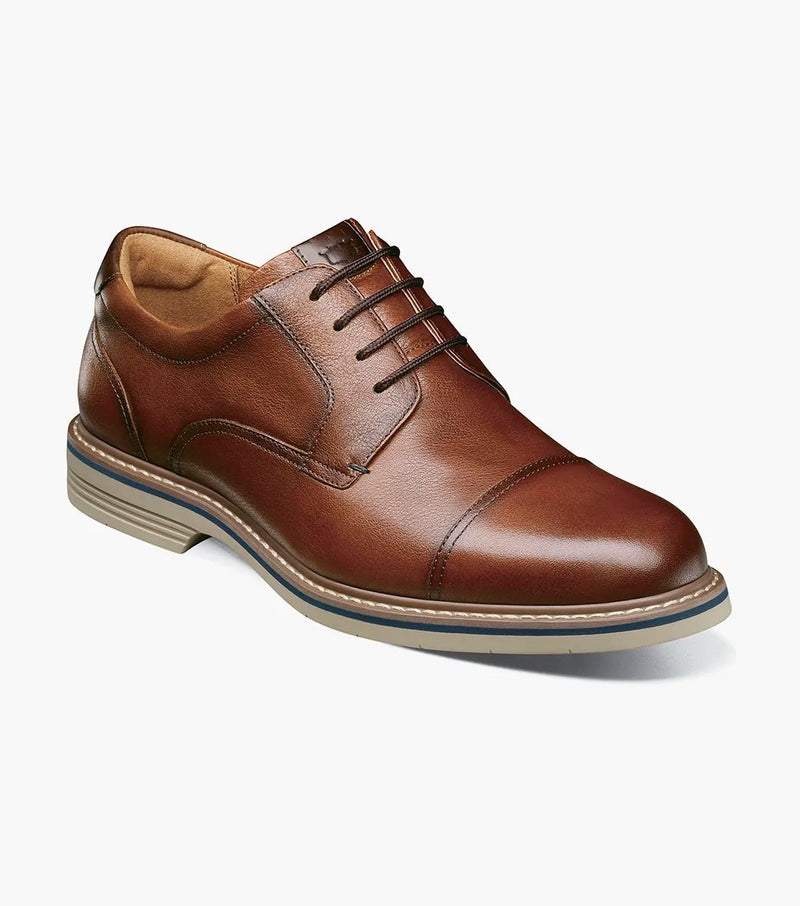 Florsheim Norwalk Cap Toe Oxford shoes in brown leather with stitched detailing and lace-up design, angled side view.