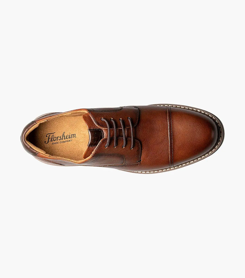 Florsheim Norwalk Cap Toe Oxford dress shoe in brown leather with fine grain texture and tonal stitching, top view showing lace-up design and cushioned interior.