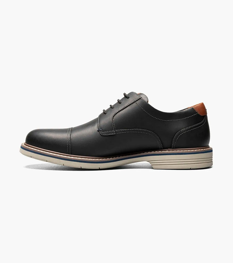 Florsheim Norwalk Cap Toe Oxford shoes in black leather with a cap toe design, contrasting tan heel tab, and white sole, side view.