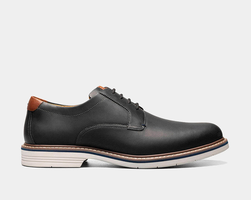 Florsheim Norwalk Plain Toe Oxford shoes, black leather upper with brown heel accent, contrast stitching, and white rubber sole, side view.