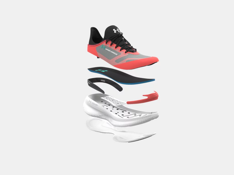 Under Armour Nova SlipSpeed™ athletic shoes in gray and red with black accents, featuring a demonstration of layered construction showcasing outsole, insole, midsole, and HOVR cushioning technology.