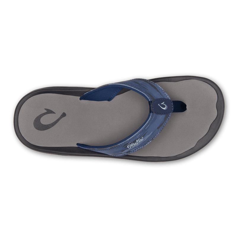 OluKai Ohana Pa'i flip-flops with blue fabric straps and a gray cushioned footbed, top view.
